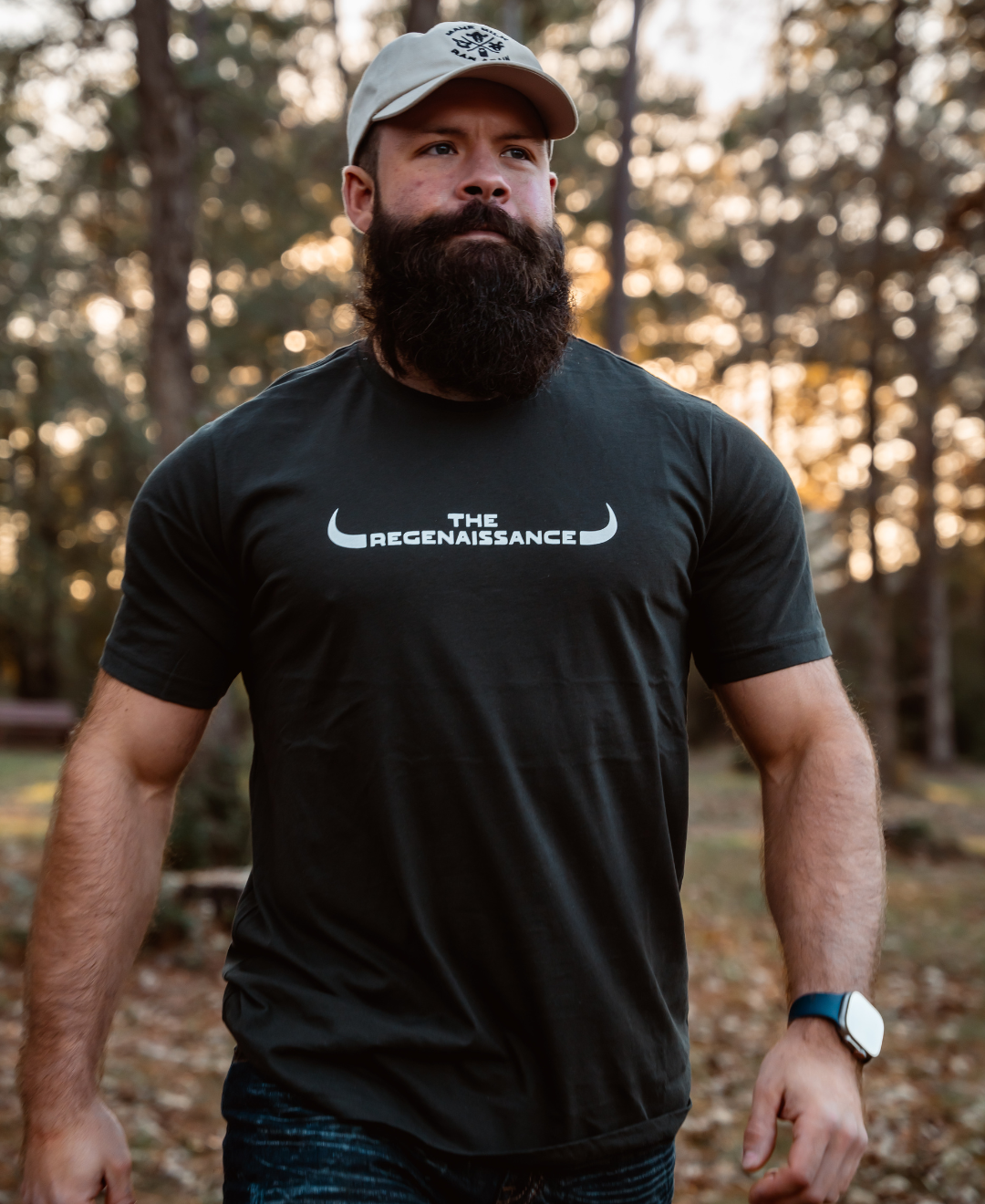 A bearded man wearing a Farm Fresh Clothing MMRA Trinity Cap embraces the spirit of food freedom.