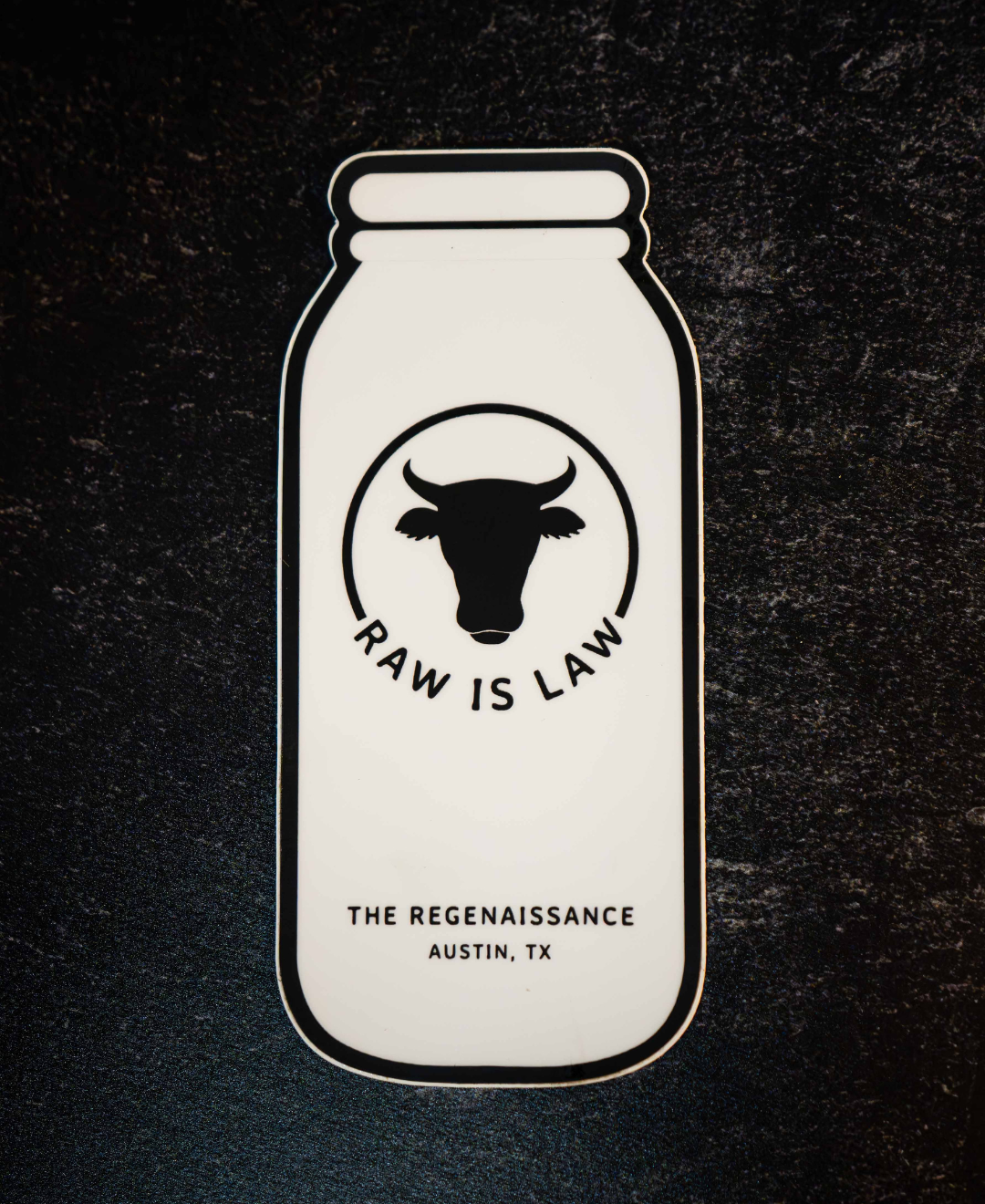 The Regenaissance Sticker Pack by Sticker Mule features a vinyl sticker shaped like a milk bottle with a cow head, RAW IS LAW, and THE REGENAISSANCE, AUSTIN, TX—celebrating real food and regenerative agriculture.