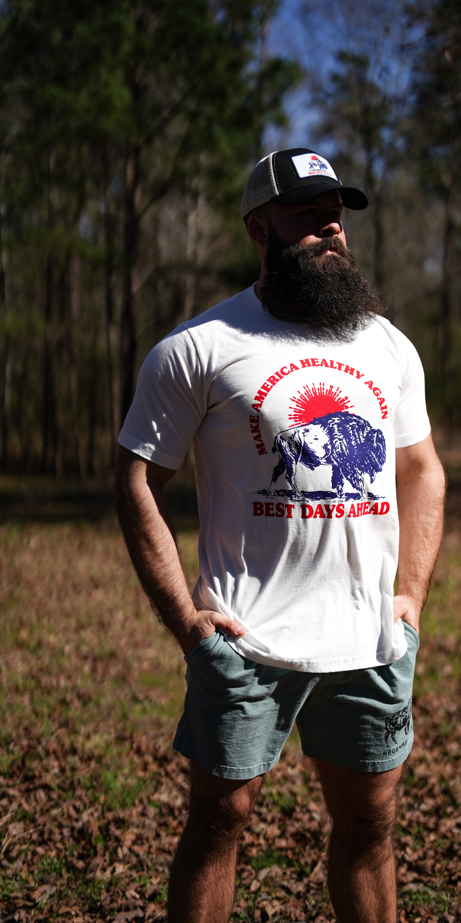 Man wearing a white MAHA Best Days Ahead t-shirt with a graphic design outdoors