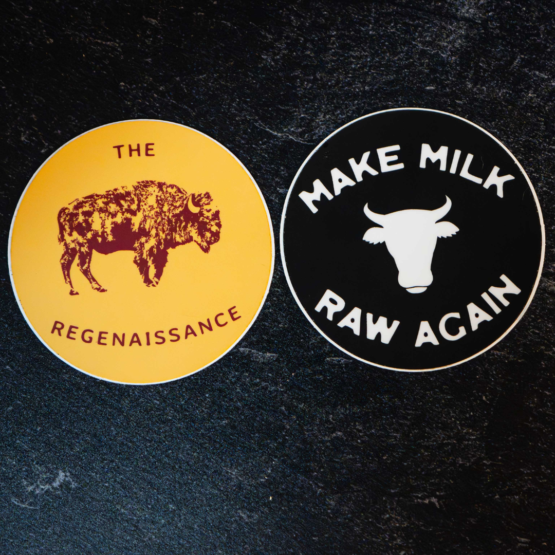 The Regenaissance Sticker Pack by Sticker Mule features two round vinyl stickers: one yellow with a bison and THE REGENAISSANCE, and one black with a cow head and MAKE MILK RAW AGAIN—great for supporters of real food.