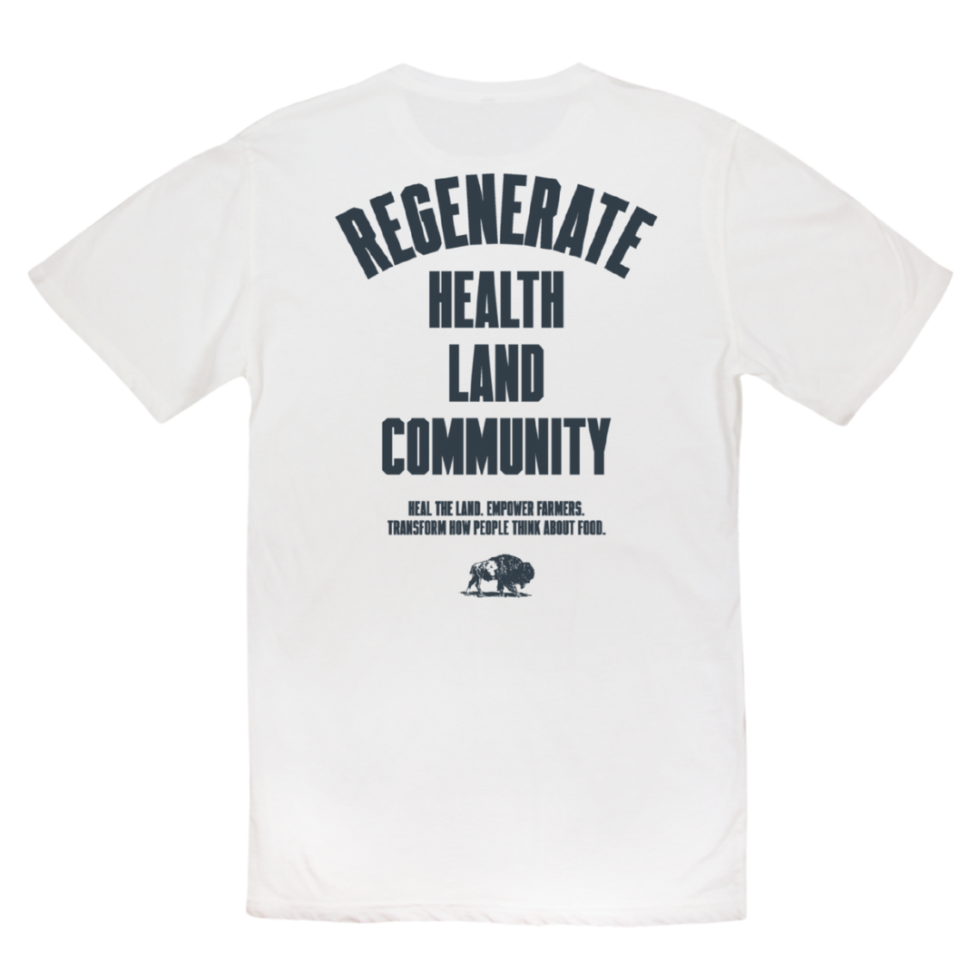 Flat lay back view of white Regenerate Agriculture Tee with bold navy text reading “Regenerate Health Land Community.”
