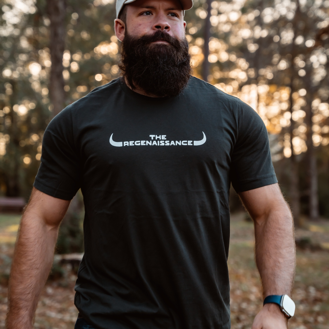 A bearded man wearing a Farm Fresh Clothing MMRA Trinity Cap embraces the spirit of food freedom.
