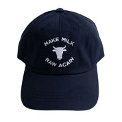 Navy cap with white text 'Make Milk Raw Again' and cow icon on a white background