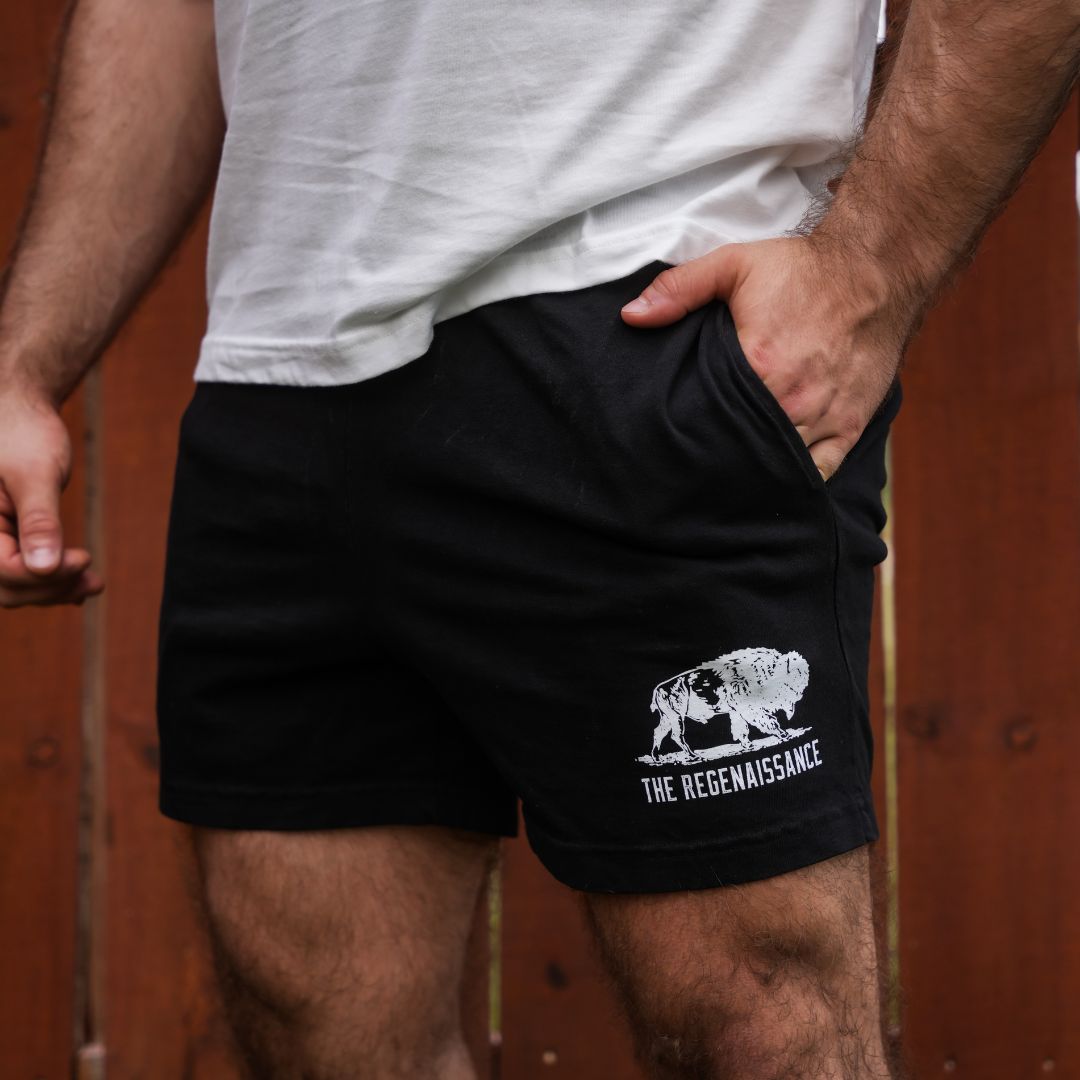 Close-up detail of black Regen Men’s Shorts highlighting fabric texture, logo embroidery, and waistband stitching.