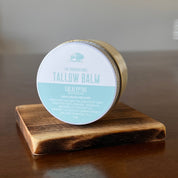Jar of Eucalyptus Tallow Balm on a wooden shelf in on its side