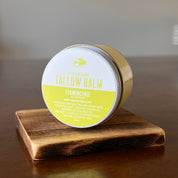 Jar of Frankincense Tallow Balm on a wooden shelf in on its side